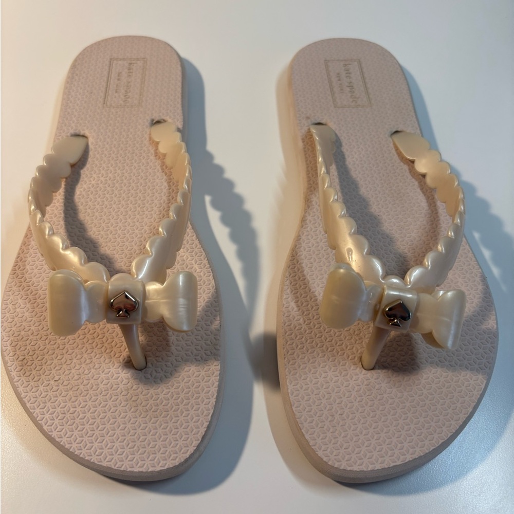Blush pearly Kate Spade Flip Flops with bow detail